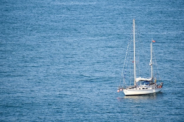 Free Photo white boat sailing in the peaceful sea at daytime