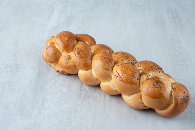 White braided bread on stone table.