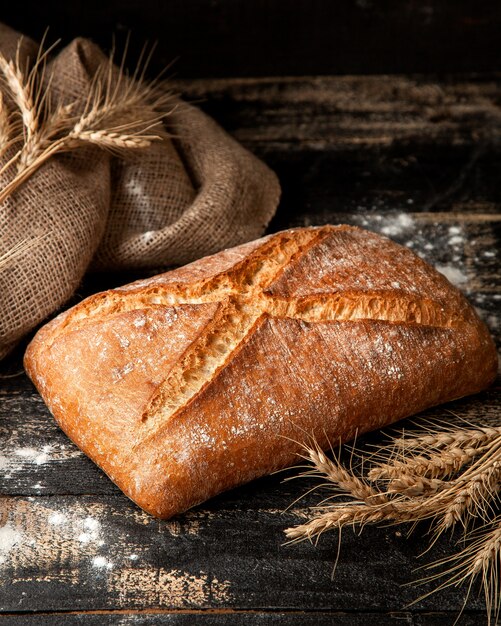 white bread with crunchy crust flour and wheat on table