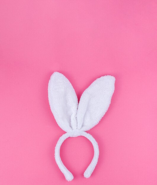 White bunny ears on pink background 