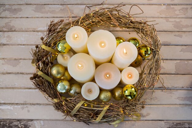 Free Photo white candles lit with christmas decoration seen from above