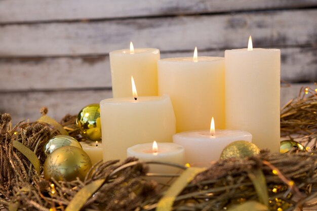 White candles lit with christmas decoration