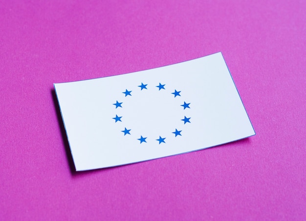 Free photo white card with european flag on purple background