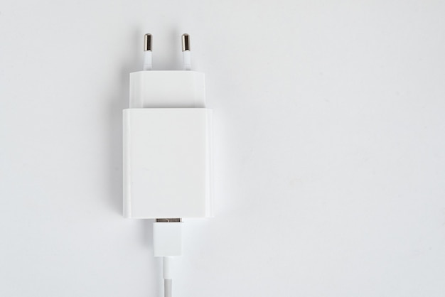 Free photo white cell phone charger on the white isolated background - with usb cabe