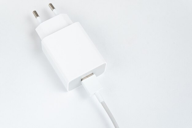 White cell phone charger on the white isolated background - With usb cabe