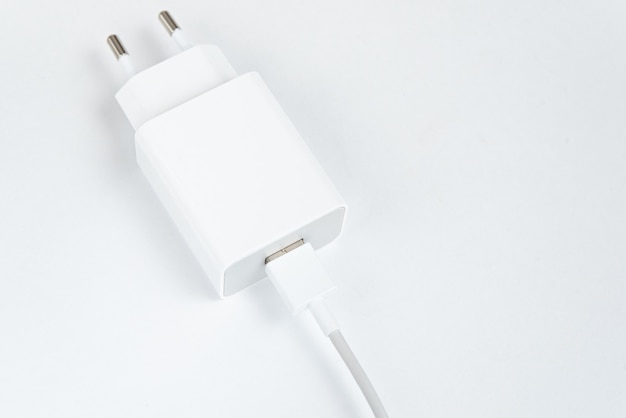 White cell phone charger on the white isolated background - With usb cabe