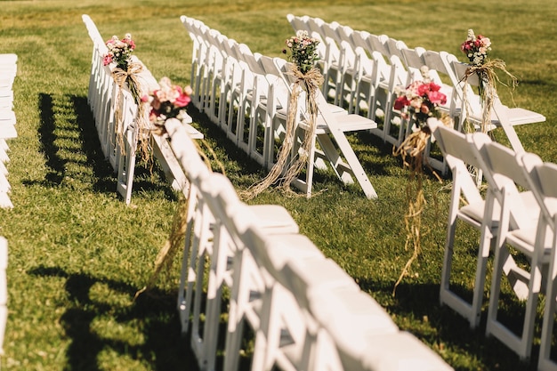 Free photo white chairs stand in long rows waiting for the beginning of wedding