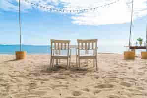 Free photo white chairs and table on beach