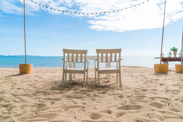 Free Photo white chairs and table on beach