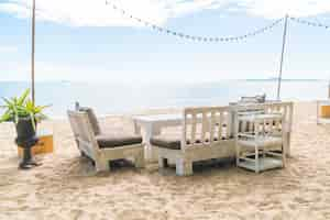 Free photo white chairs and table on beach