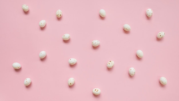 Free photo white chicken eggs scattered on pink table