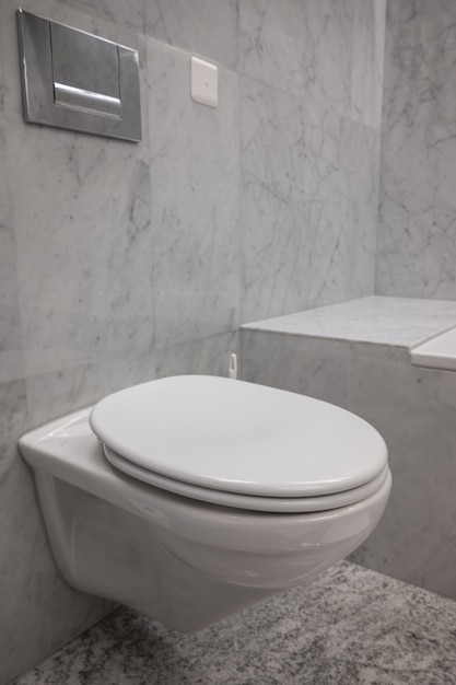 Free Photo white and clean toilet with the stone walls in a bathroom