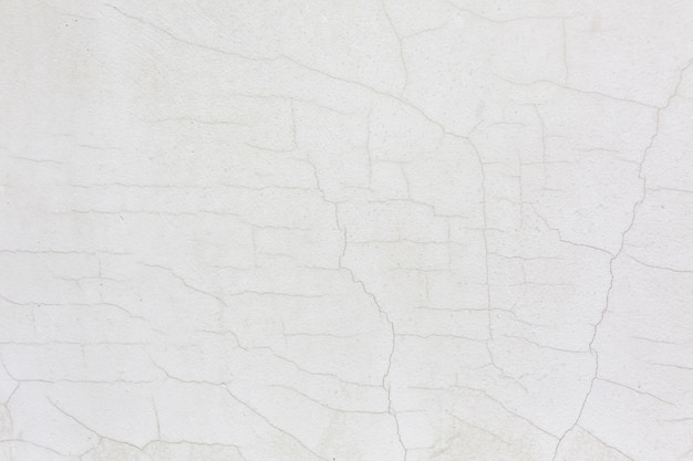 Free photo white cracked wall stucco texture background