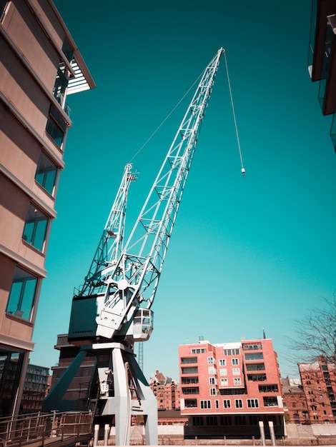 Free photo white crane on construction site in city