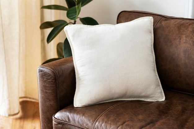 Free Photo white cushion on a leather couch