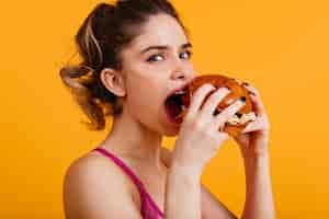 Free photo white cute woman eats hamburger