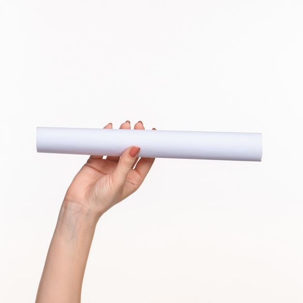 white cylinder of the props in the female hands on white background