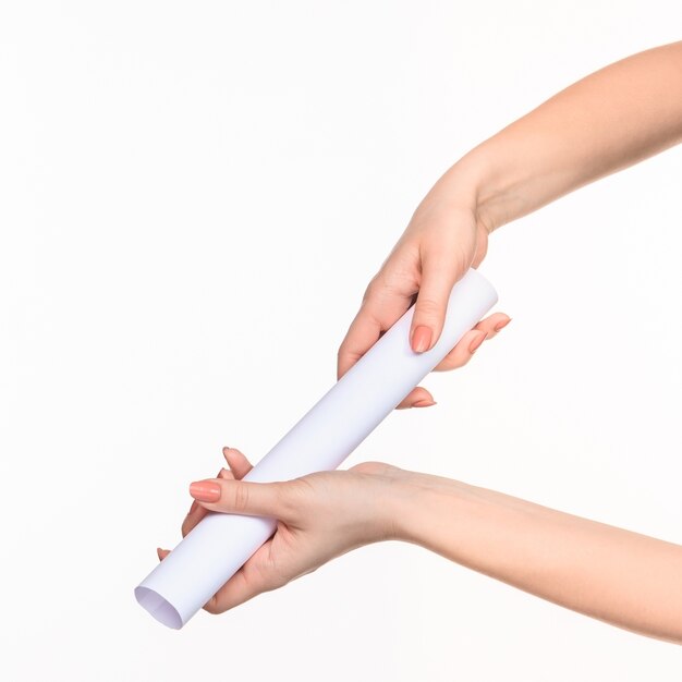 white cylinder of the props in the female hands on white background