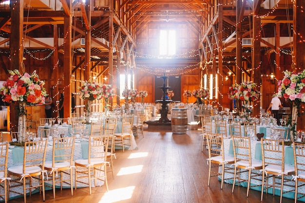 Free photo white daylight illuminates a wooden hangar prepared for a wedding