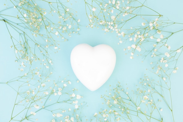 Free Photo white decorative heart between plants