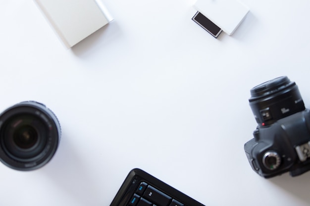 White desk with a professional camera and accessoires