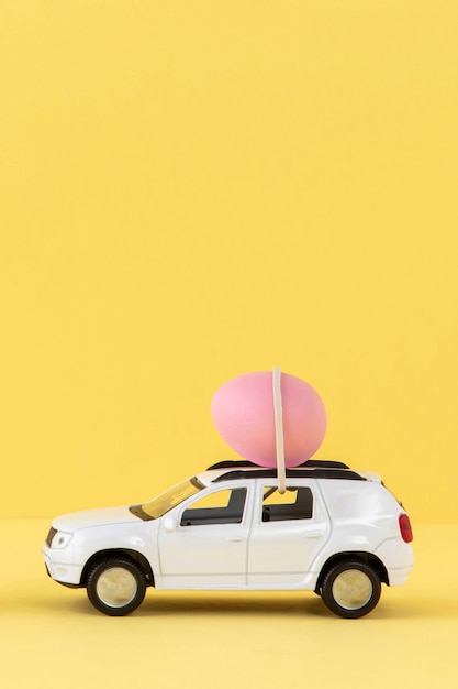 Free photo white easter car with pink egg