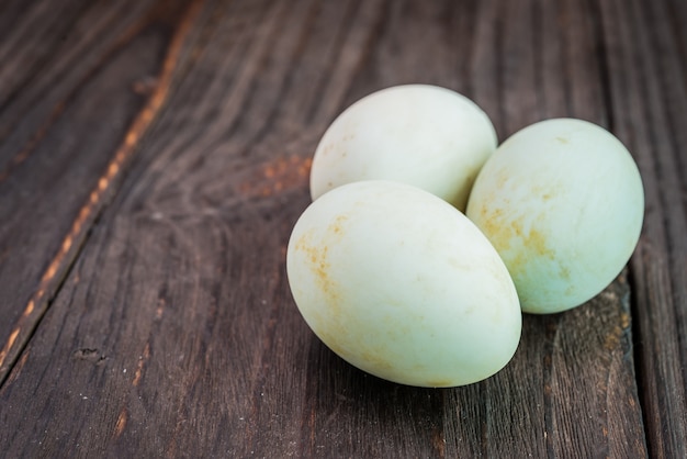 White egg on wooden background