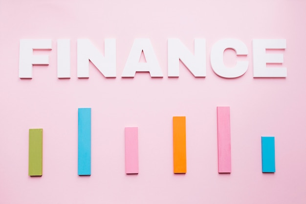 Free Photo white finance text over the colored bar graph on pink background