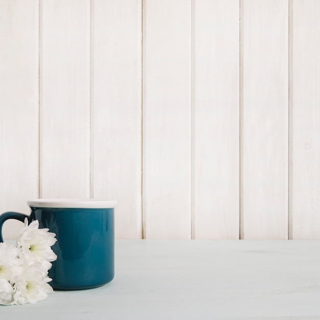 Free photo white flowers near mug