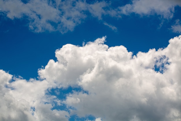 White fluffy clouds in the clear sky