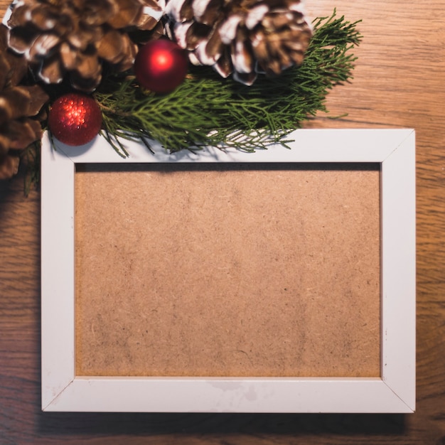 Free photo white frame with christmas decoration