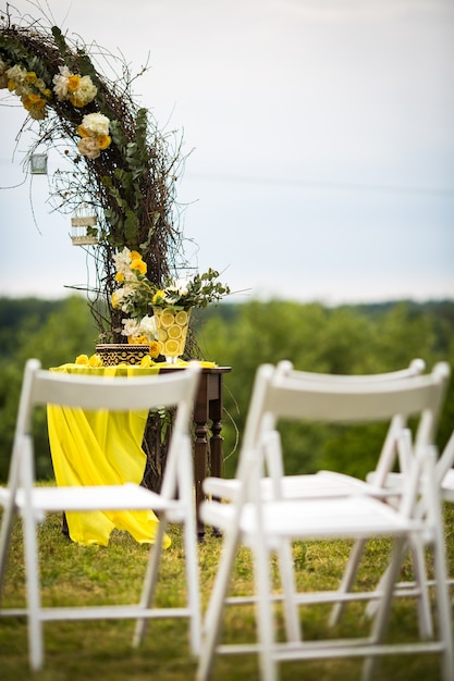 Free photo white garden chairs stand before wedding altar made of osier