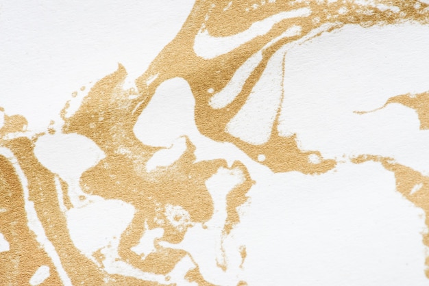 Free photo white and gold fluid art marbling paint textured background