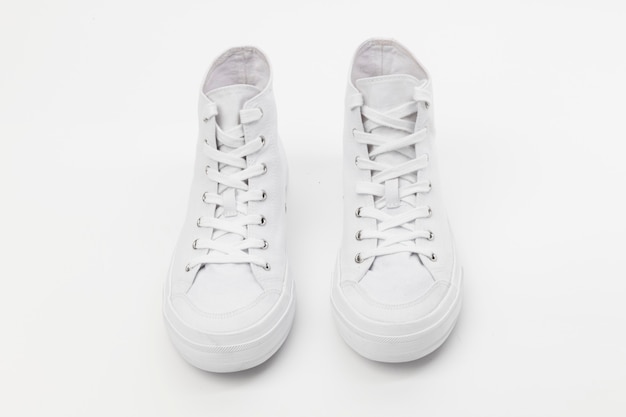 Free photo white high top sneakers unisex footwear fashion