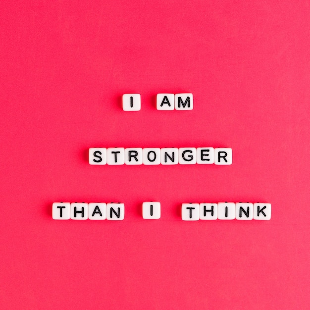 Free photo white i am stronger than i think beads words typography on red