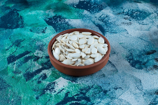 White kernels in a bowl , on the marble table.