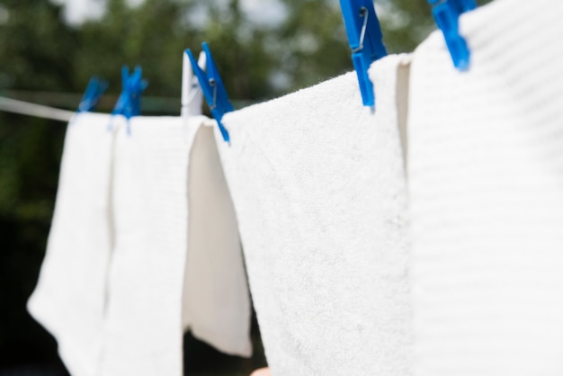 Free photo white laundry hanging on a string outdoors