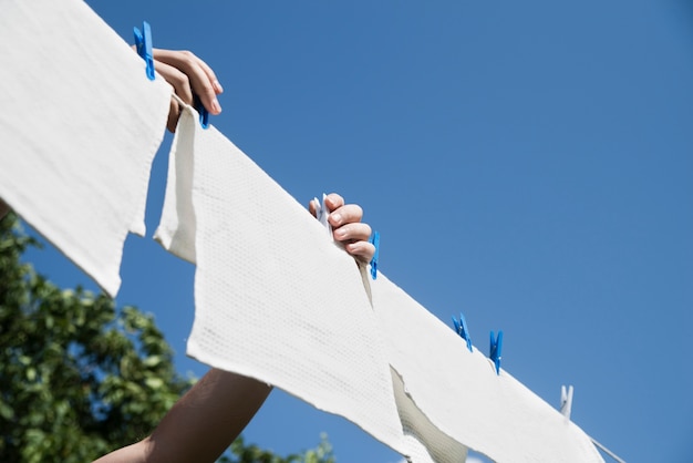 Free photo white laundry hanging on a string outdoors