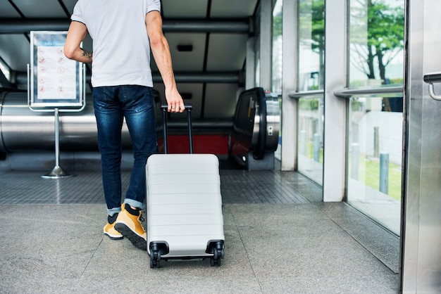 White man carrying luggage