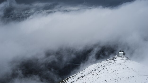 White mountain under white clouds at daytime