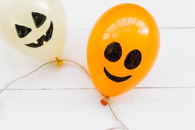 White and orange air balloons with creepy painted faces