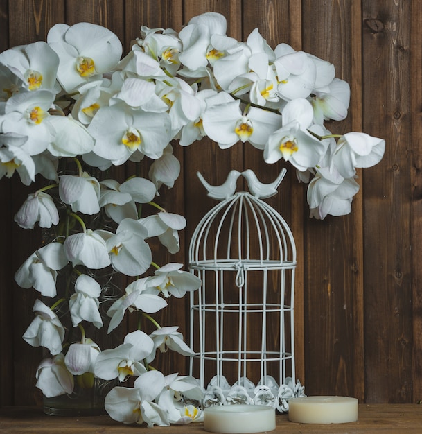 Free Photo white orchidea wreath and artificial cage