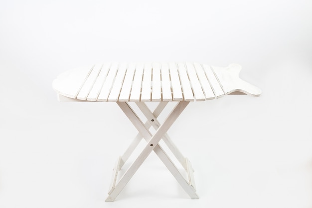 White picnic table isolated on a white wall