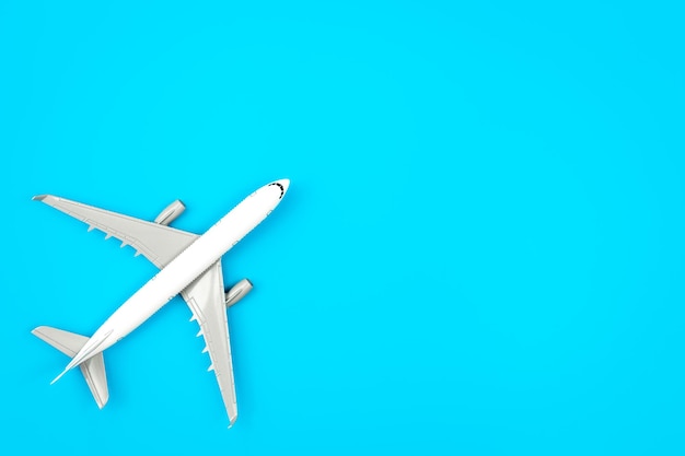 Free photo white plane airplane on a blue background flat lay copy space