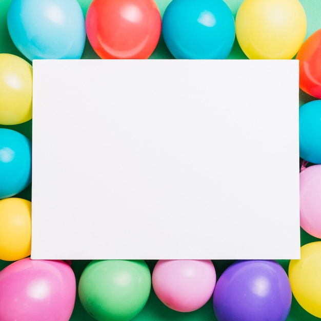 White plank card over the colorful balloons