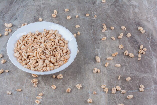 A white plate full of crisped rice breakfast cereal .