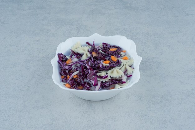 White plate of macaroni and cabbage on white plate. High quality photo