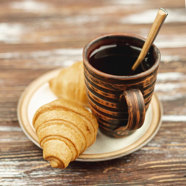 White plate with croissants and coffee cup