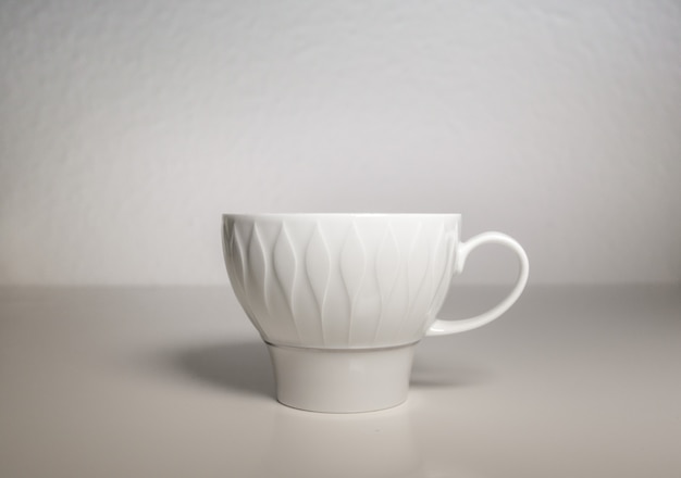 Free Photo a white porcelain cup on a white background