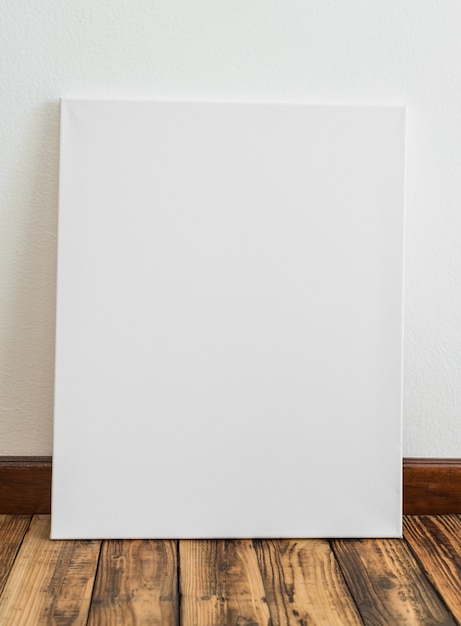 Free Photo white poster leaning against a wall